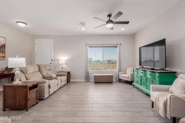 a living room with furniture and a large window