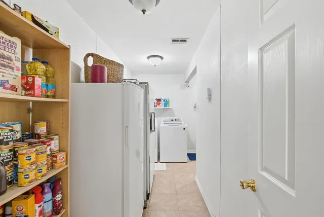 a spacious bedroom with a bed and a chandelier