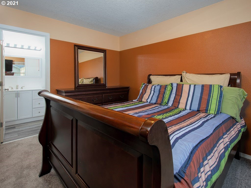 20078 Southwest Monson Street Beaverton, OR 97003 - Photo 17 of 32 a bedroom with a bed and dresser