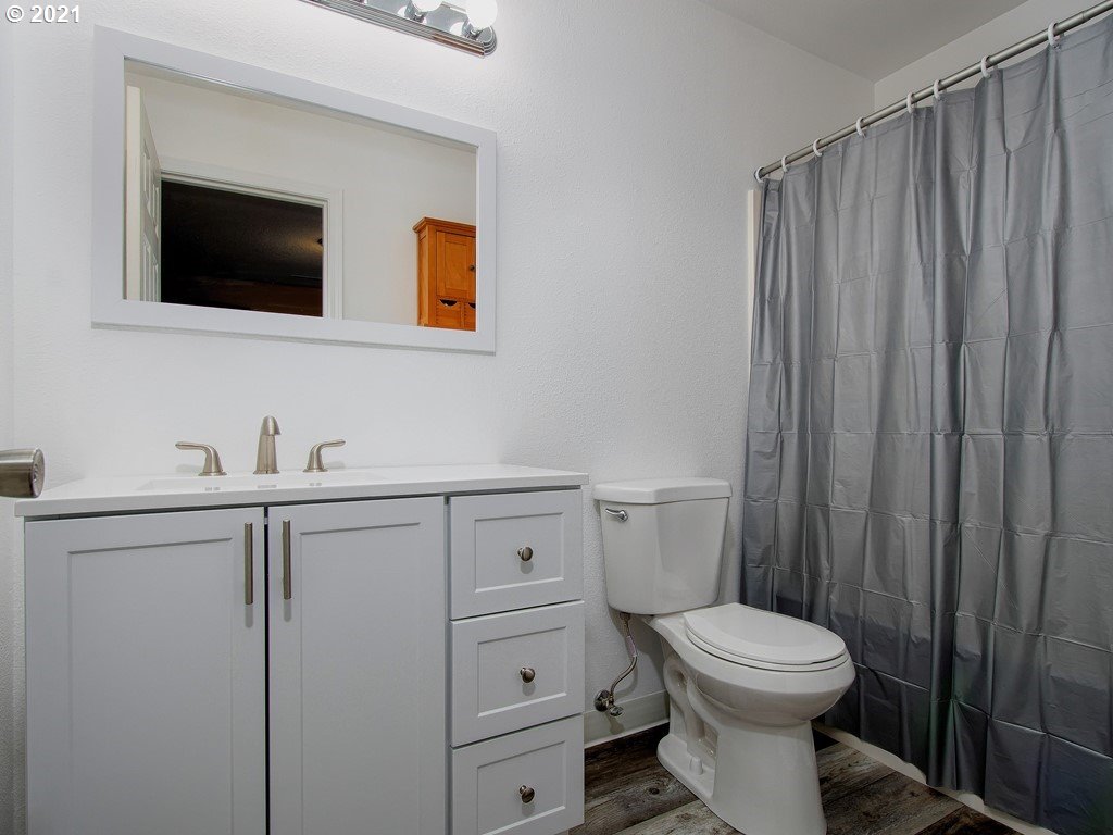 20078 Southwest Monson Street Beaverton, OR 97003 - Photo 19 of 32 a bathroom with a toilet a sink and mirror