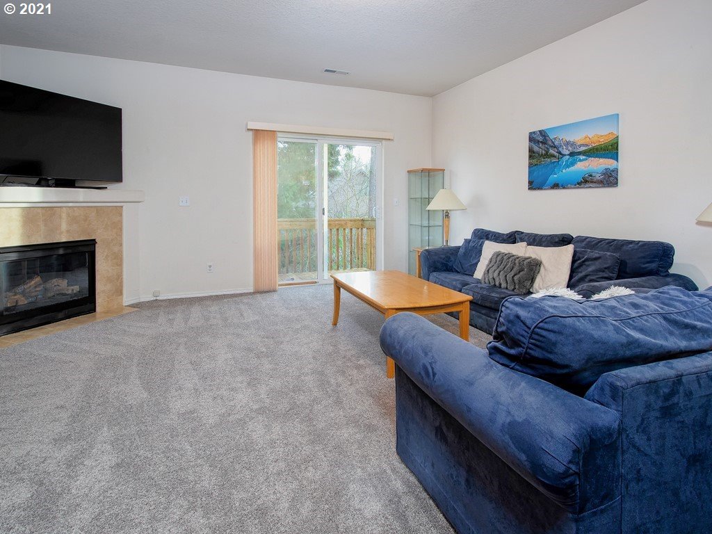 20078 Southwest Monson Street Beaverton, OR 97003 - Photo 3 of 32 a living room with furniture and a flat screen tv