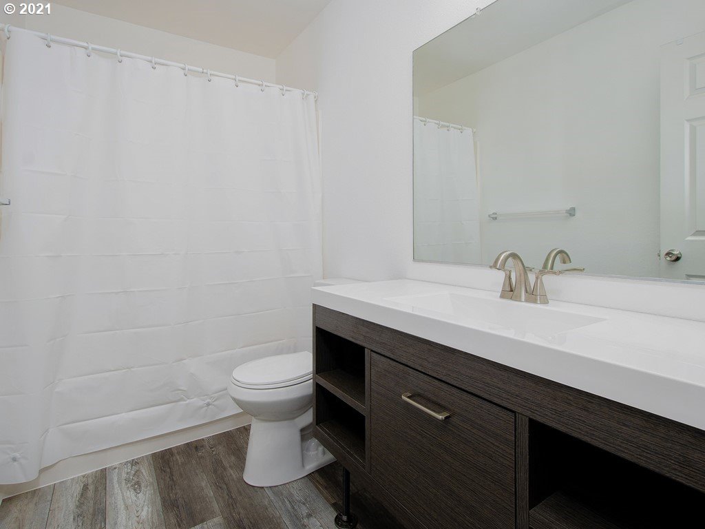 20078 Southwest Monson Street Beaverton, OR 97003 - Photo 24 of 32 a bathroom with a sink a toilet and a mirror