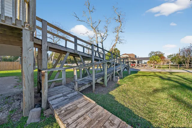 a view of a house with a big yard and large trees