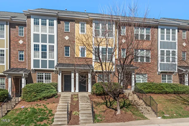 front view of a brick house with a large window