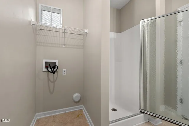a bathroom with a glass shower door