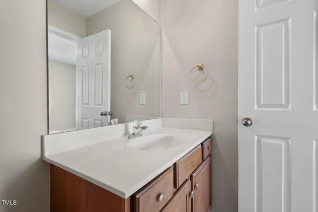 a bathroom with a sink vanity and a mirror