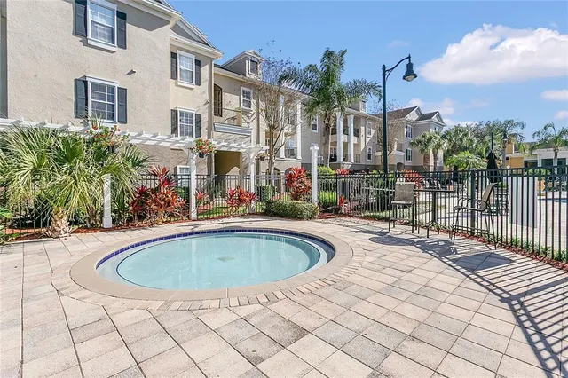 a view of swimming pool with outdoor seating and plants