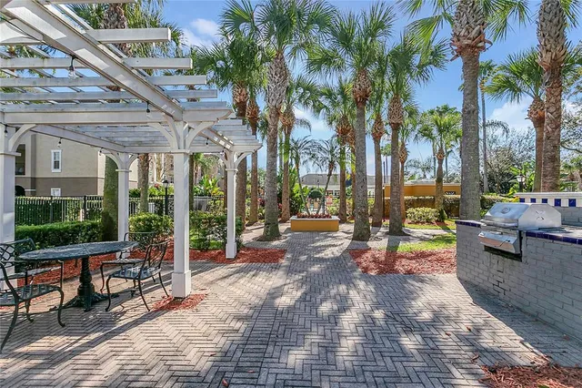 a view of a patio with couches and table and chairs with wooden floor and fence