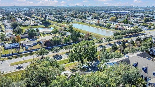 an aerial view of residential houses with outdoor space and river