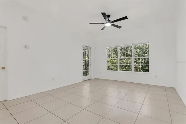 a view of a livingroom with a ceiling fan and window