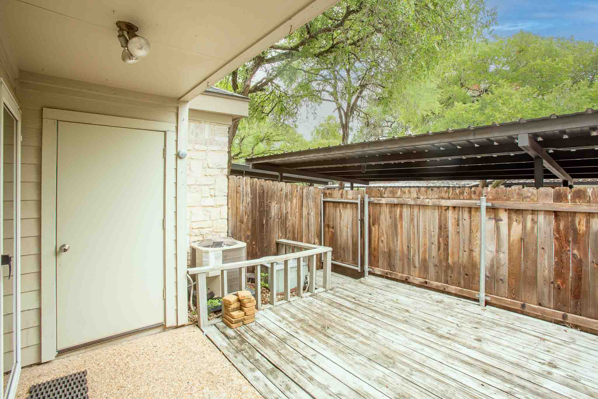 9226 Jollyville Road, Unit 132 Austin, TX 78759 - Photo 13 of 15 A spacious private deck, perfect for outdoor living, features a privacy fence and covered carport.