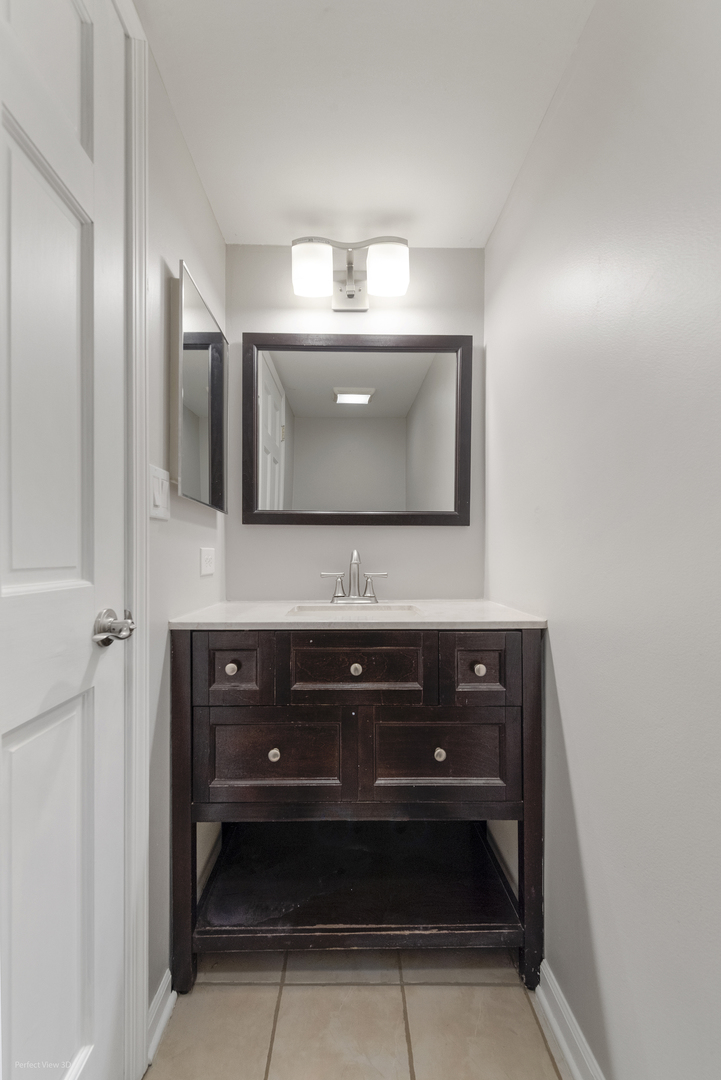 3290 Johnsbury Court Aurora, IL 60504 - Photo 13 of 31 a bathroom with a sink and a mirror