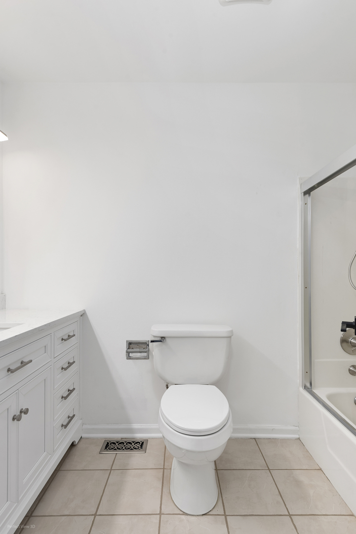 3290 Johnsbury Court Aurora, IL 60504 - Photo 17 of 31 a bathroom with a toilet a sink and mirror