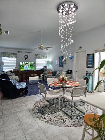a living room with lots of furniture and a chandelier