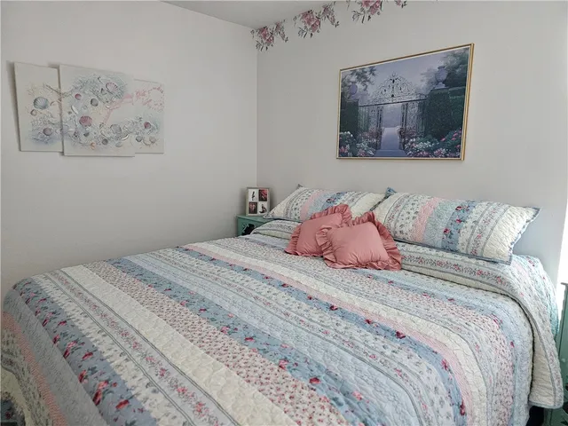 a bedroom with a bed and the wall painting