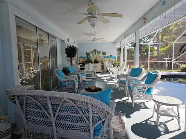 a living room with furniture a chandelier and a fireplace