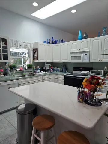 a kitchen with a sink a stove and cabinets