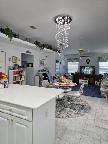 a living room with lots of furniture and a chandelier