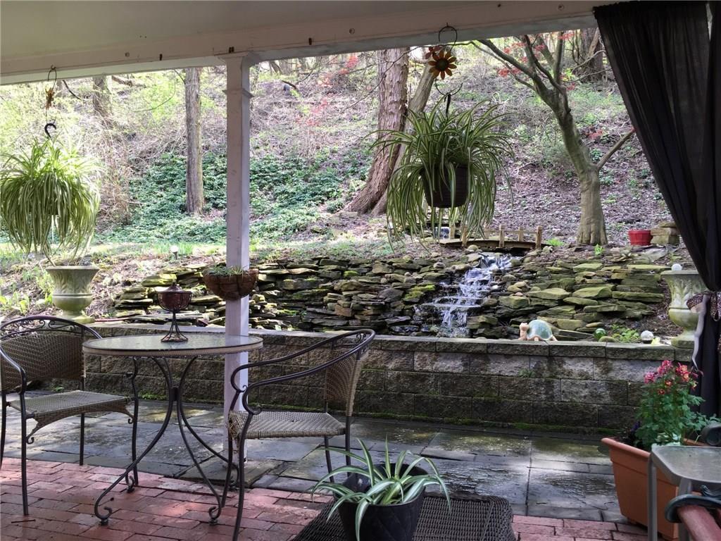924 Roland Road Pittsburgh, PA 15221 - Photo 17 of 23 pond and waterfall which were professionally designed and installed.