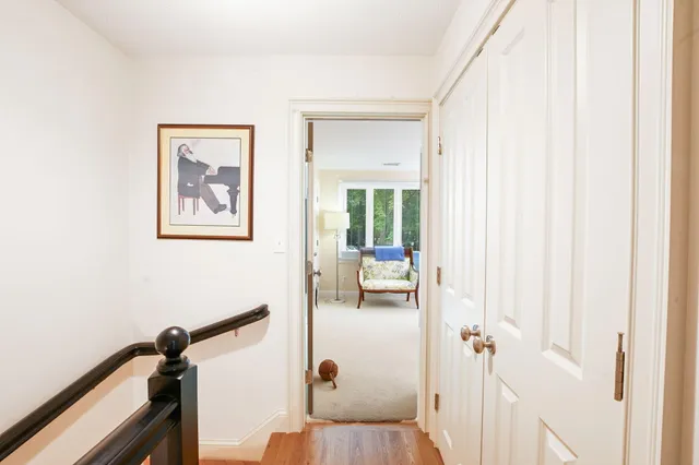 a view of a brick house with a yard and plants