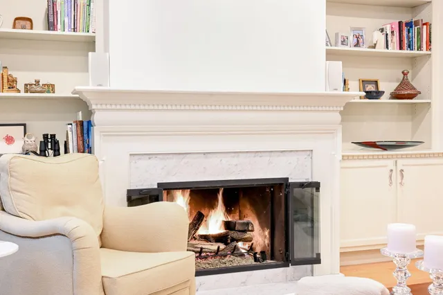 a living room with a fireplace and a flat screen tv