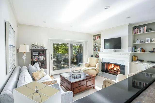 a very nice looking dining room with a large window and table