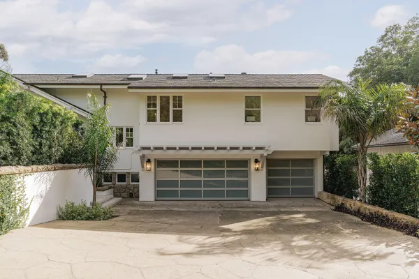 a front view of a house with garden
