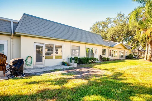 a view of a house with swimming pool and sitting area