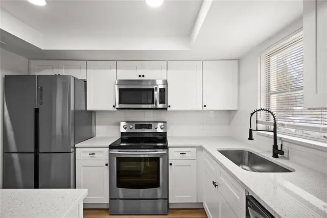 a kitchen with a sink stove and refrigerator