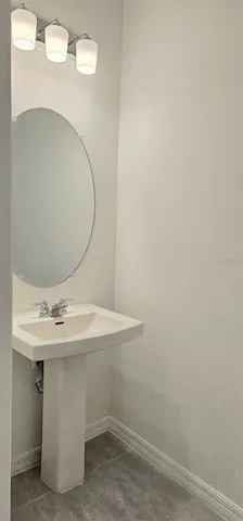 a bathroom with a sink and mirror