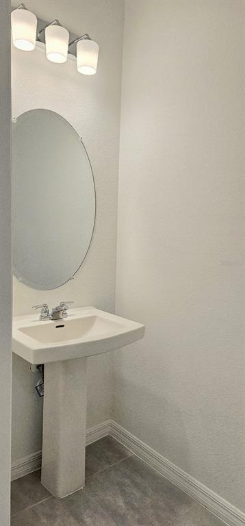 5000 Revolutionary Way St. Cloud, FL 34769 - Photo 19 of 32 a bathroom with a sink and mirror