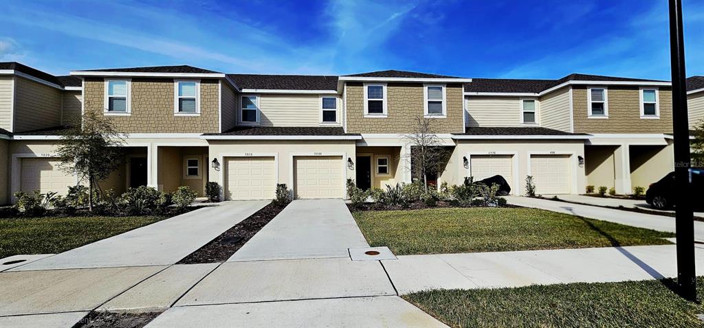 5000 Revolutionary Way St. Cloud, FL 34769 - Photo 2 of 32 a front view of a house with a yard