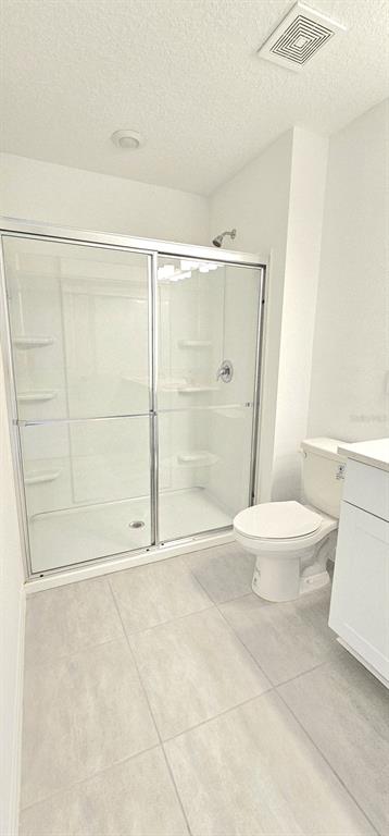 5000 Revolutionary Way St. Cloud, FL 34769 - Photo 27 of 32 a bathroom with a toilet and a shower