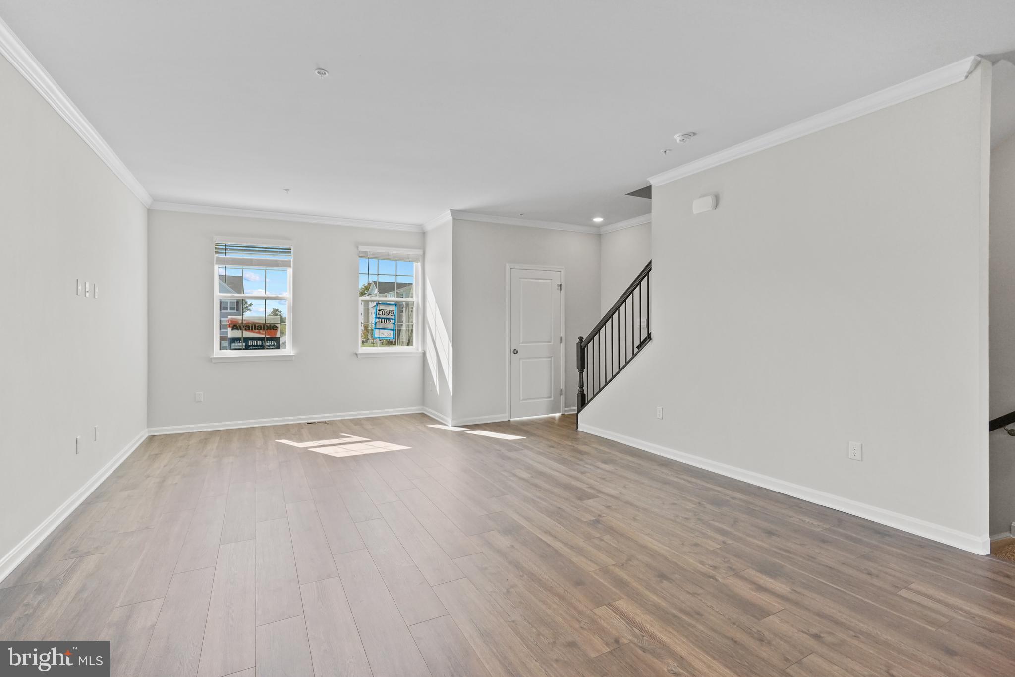 8709 Tavern Street Clinton, MD 20735 - Photo 16 of 25 a view of an empty room with wooden floor and a window