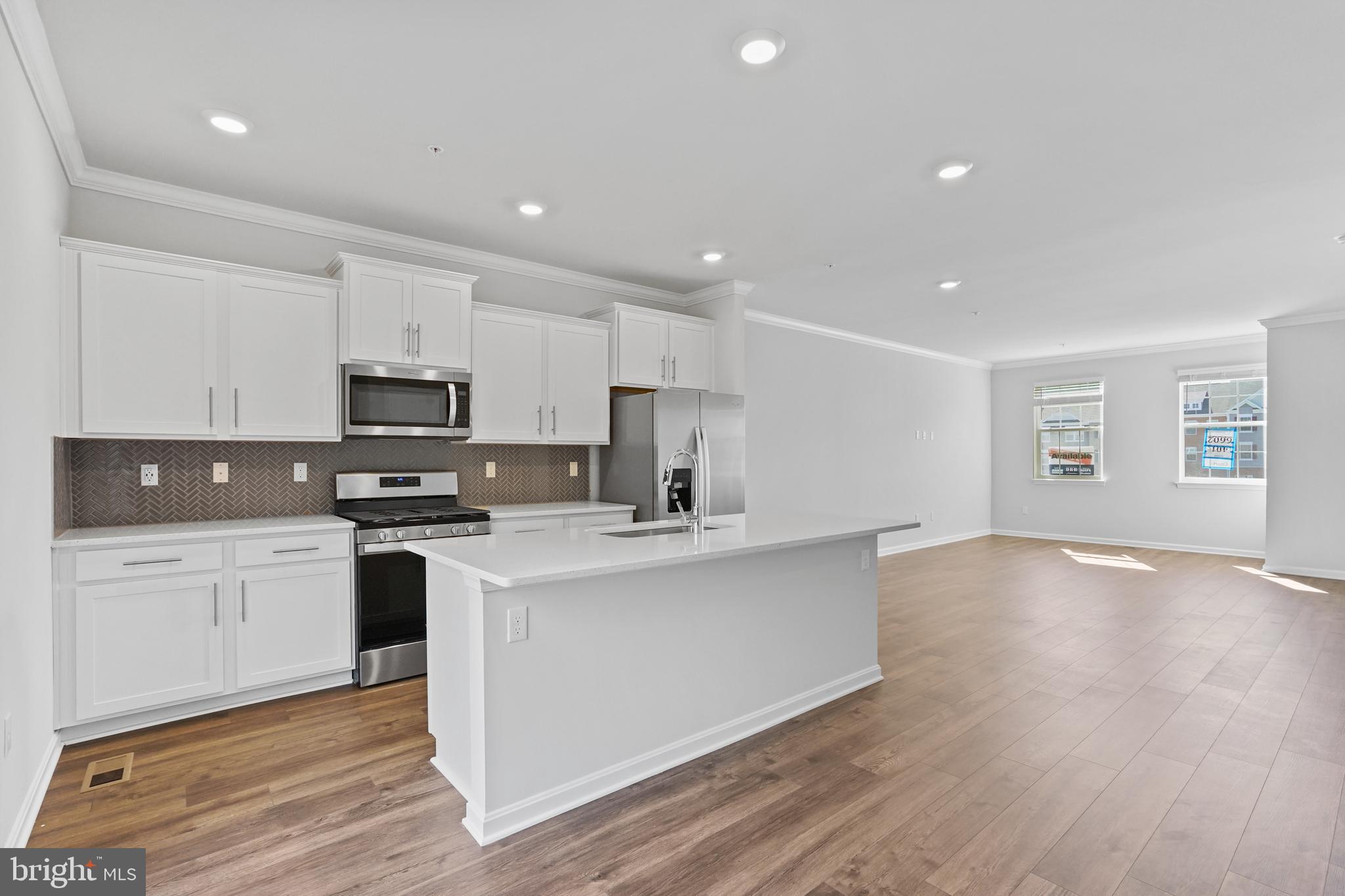 8709 Tavern Street Clinton, MD 20735 - Photo 19 of 25 a kitchen with stainless steel appliances a white stove top oven sink and cabinets