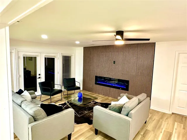 a living room with furniture and wooden floor