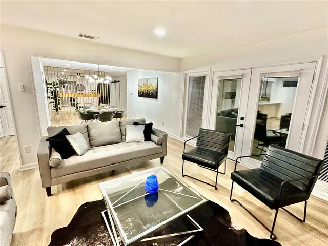 a living room with furniture and wooden floor