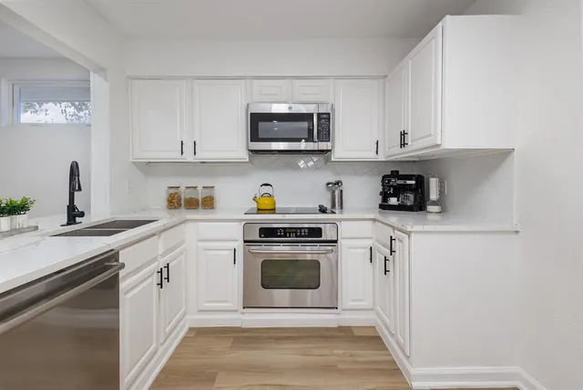 an empty room with a window and ceiling fan