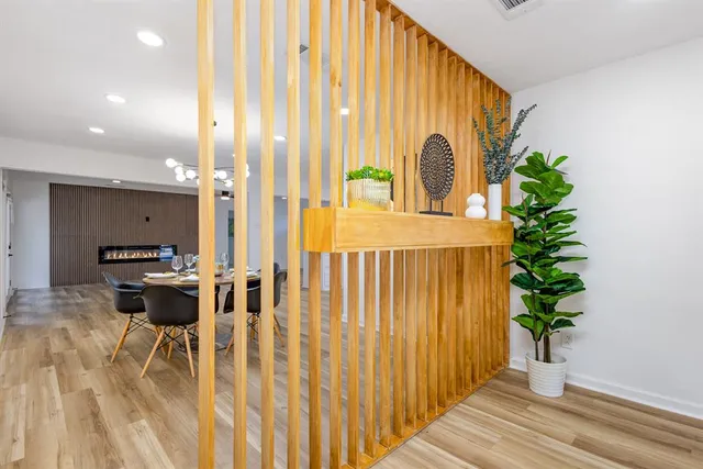 a view of a patio with table and chairs with wooden floor