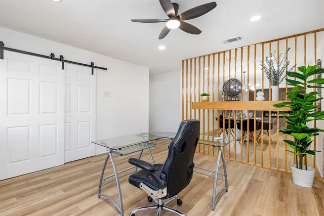 a view of a workspace with furniture and a window
