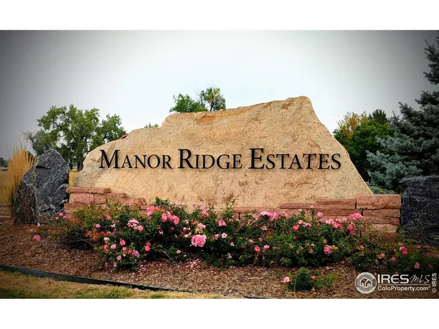 a sign that is sitting in front of flowers