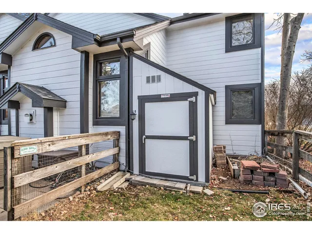 a view of backyard of house with wooden floor and outdoor seating