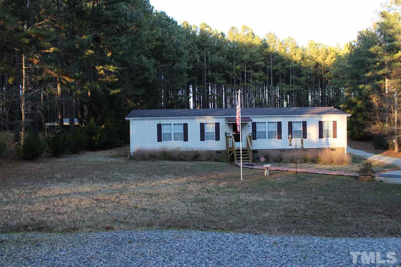 141 Waters Edge Road Henderson, NC 27537 - Photo 2 of 30 a view of a yard in front of a house with large trees