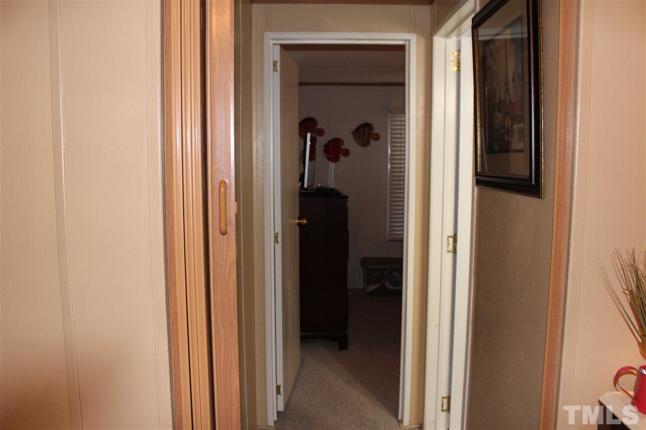 141 Waters Edge Road Henderson, NC 27537 - Photo 14 of 30 a view of a bedroom from a hallway