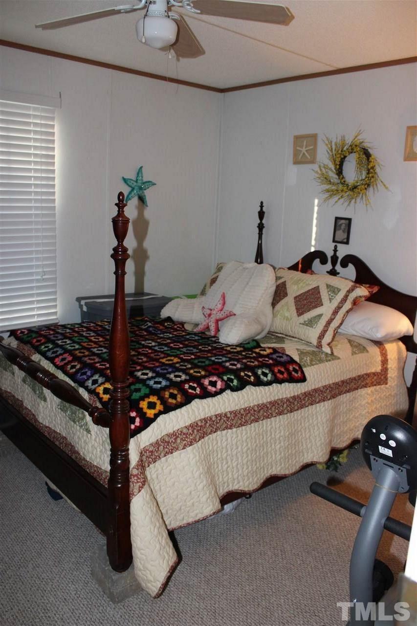 141 Waters Edge Road Henderson, NC 27537 - Photo 16 of 30 a bedroom with a bed and window