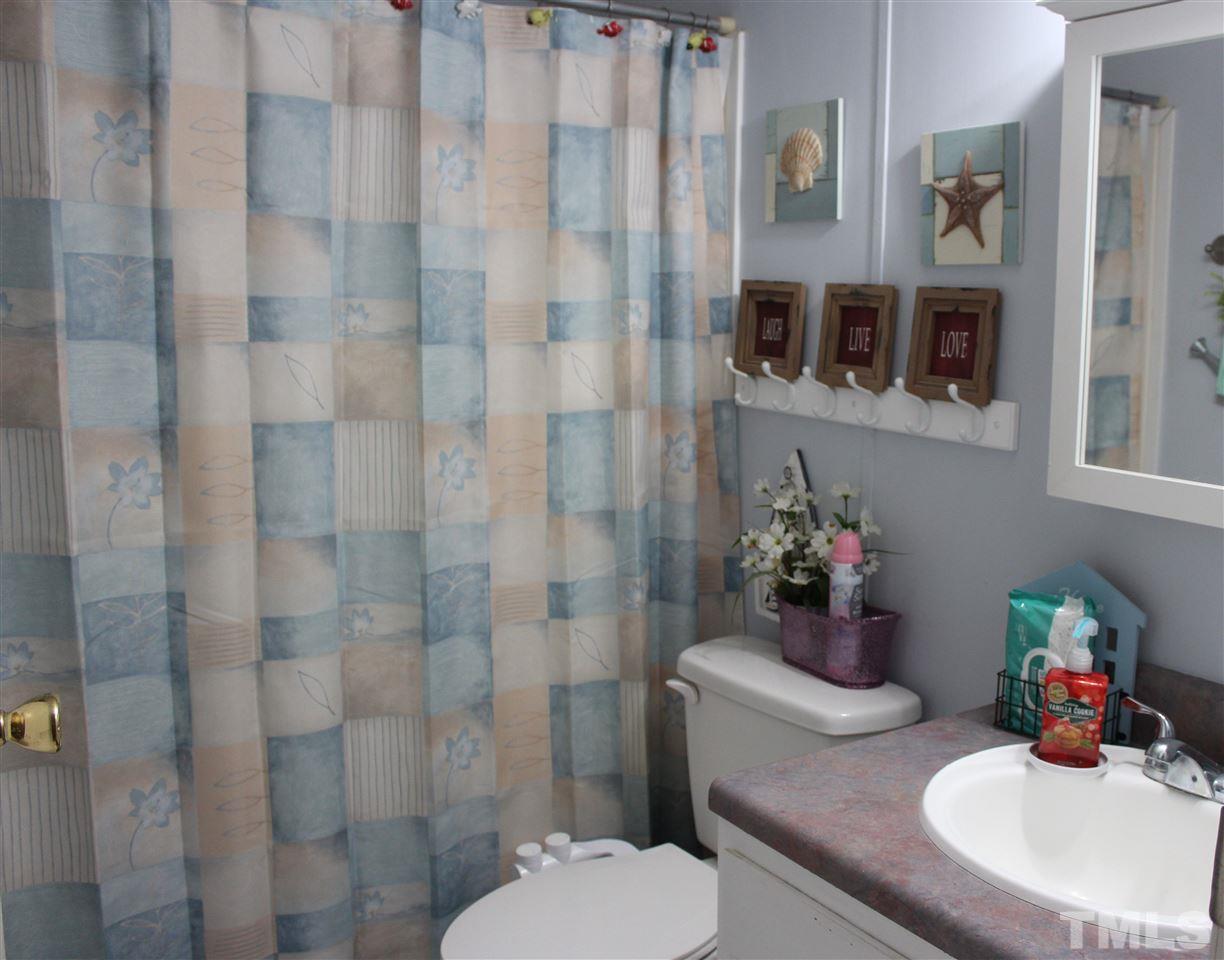 141 Waters Edge Road Henderson, NC 27537 - Photo 17 of 30 a bathroom with a sink toilet and shower