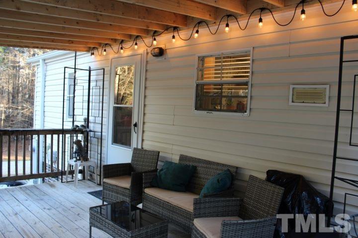 141 Waters Edge Road Henderson, NC 27537 - Photo 19 of 30 a view of a porch with furniture and wooden floor