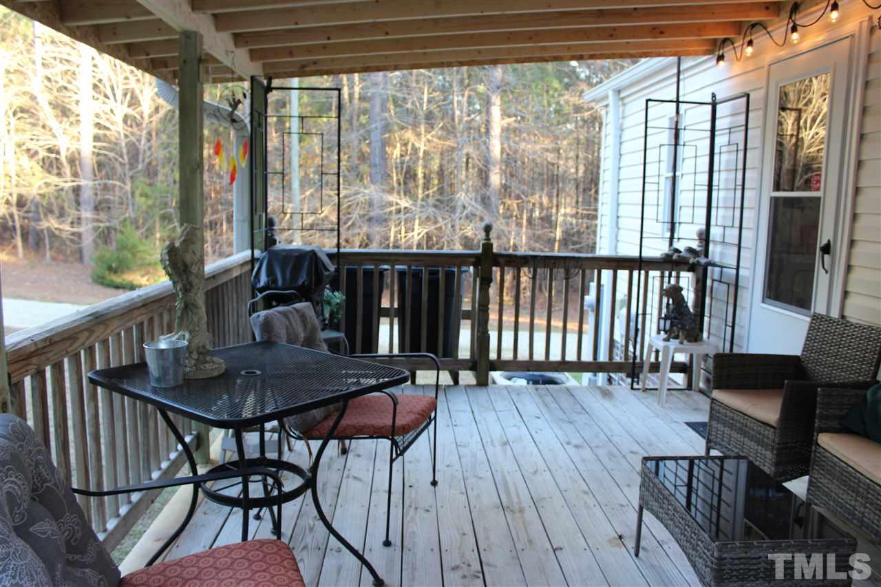 141 Waters Edge Road Henderson, NC 27537 - Photo 20 of 30 a view of a dining room with furniture window and wooden floor