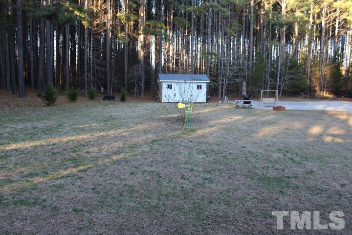 141 Waters Edge Road Henderson, NC 27537 - Photo 22 of 30 a view of a house with backyard and trees