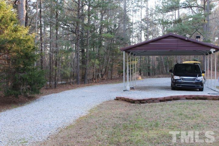 141 Waters Edge Road Henderson, NC 27537 - Photo 25 of 30 a backyard of a house with barbeque oven